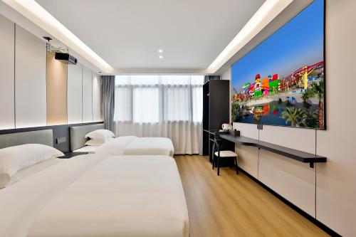 a hotel room with two beds and a video game on the wall at WEN SI TE HOTEL in Shangta
