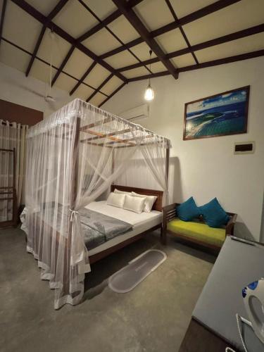 a bedroom with a bed with a canopy at Villa SeaLoom in Galle