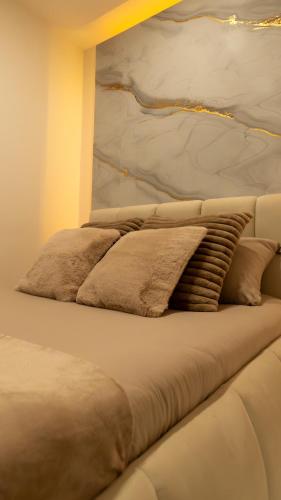 a bed with a pillow on top of it at MagicSpa Gold in Chilly-Mazarin