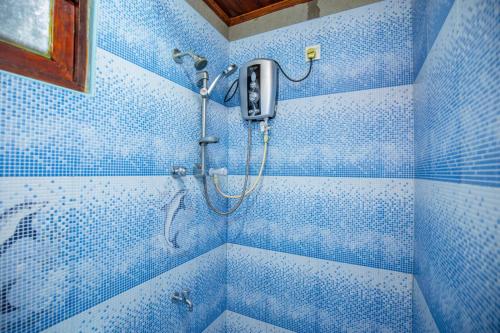 a blue tiled shower in a blue bathroom at Rithu villa in Hikkaduwa