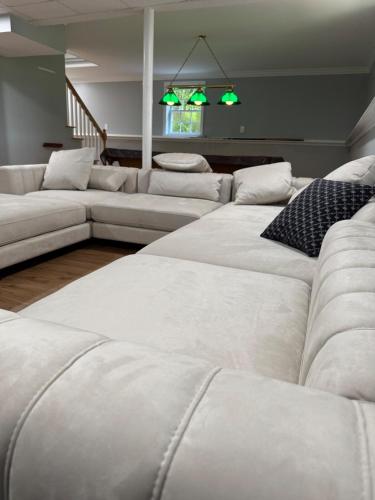 a living room with white couches and a couch at Serene waterfront getaway in Mashpee
