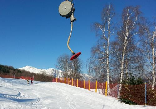 a person on a ski slope with a snowboard in the air at Albergo Genzianella in Careggine