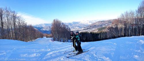 two people standing on skis in the snow at Albergo Genzianella in Careggine