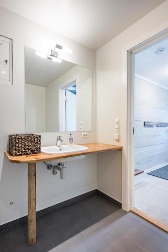 a bathroom with a sink and a mirror at Hattvika Lodge in Ballstad