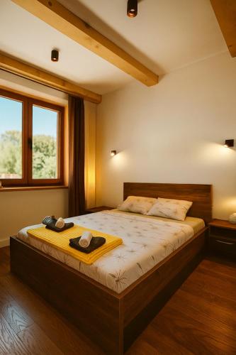a bedroom with a bed with two hats on it at Orahovo stone vilas in Virpazar