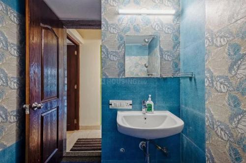a blue bathroom with a sink and a mirror at Celeste holiday homes in Calangute