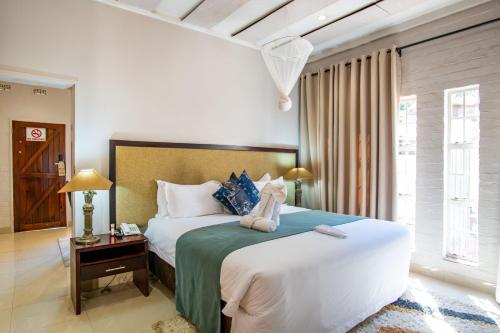a bedroom with a large bed in a room at Kadoma Hotel & Conference Centre in Kadoma