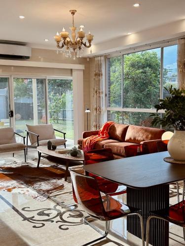 a living room with a couch and a table at Private Rm in a Stylish Chatswood Home Near Station in Sydney