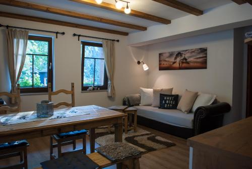 a living room with a couch and a table at Haus Waldfrieden in Kurort Altenberg