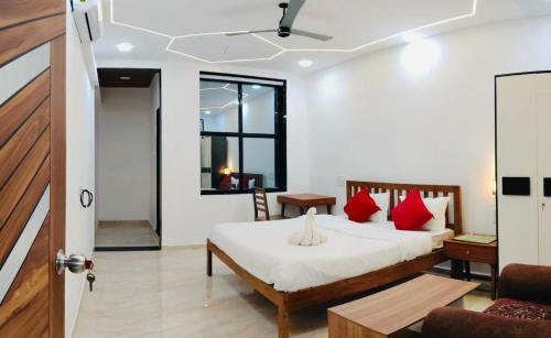a bedroom with a bed with red pillows at Greenwood Resort in Dhamni