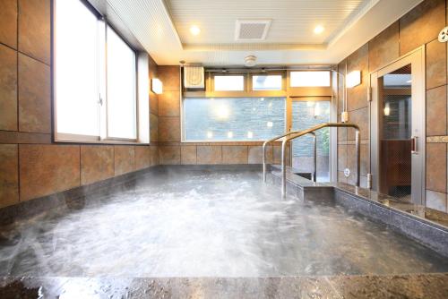 a room with a pool of water in a bathroom at Hotel Coco Grand Kitasenju in Tokyo