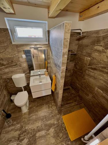 a bathroom with a toilet and a sink and a shower at Jolcsi Apartman in Balatonfüred