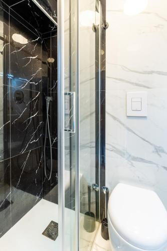 a bathroom with a toilet and a glass shower at APARTAMENT CHIARA - accanto alle scale dell amore - Julia Vieste in Vieste