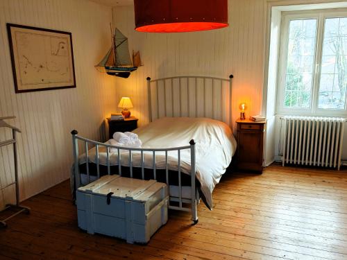 a bedroom with a bed and two tables and a window at Villa Simone - 200m de la Plage in Les Sables-d'Olonne