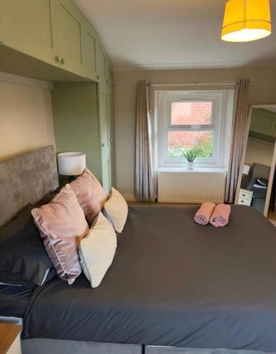 a couch with pillows on it in a living room at Beautiful Countryside Cottage Alnwick in Alnwick