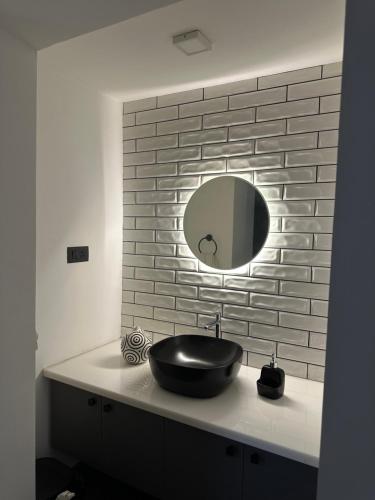 a bathroom with a black sink and a mirror at Asramom Home in Kollam