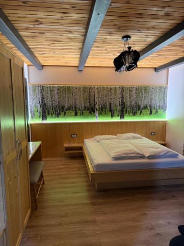 a bedroom with a bed and a green aquarium at Casa Bunicii in Şarul Dornei