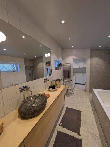 a bathroom with a large tire sink on a counter at Lofoten Seaside House in Offersøya