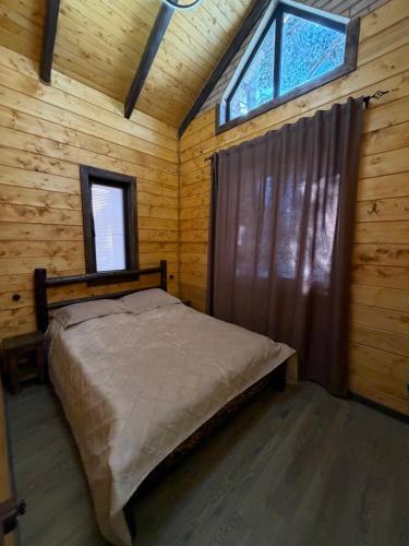 a bedroom with a bed in a wooden cabin at Arte Jermuk #3 in Jermuk