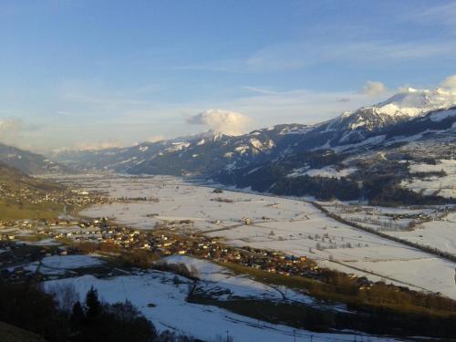 an aerial view of a town with snow covered mountains at Haus Deutinger in Piesendorf