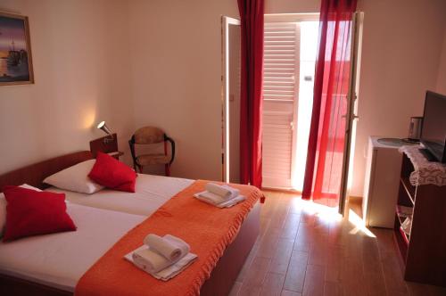 a bedroom with a bed with two towels on it at Guest House Stefica in Hvar