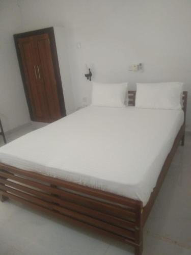 a bed in a room with a white mattress at Jayasri in Hikkaduwa