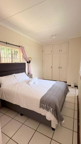 a bedroom with a large bed in a room at Gaxela Space in Pietermaritzburg