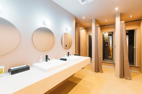 een badkamer met twee wastafels en twee spiegels bij Nagasaki House Burabura in Nagasaki