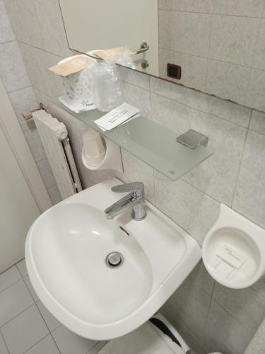 a white bathroom with a sink and a toilet at Hotel Sanmicheli in Verona