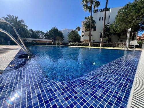 a swimming pool with blue tiles on it at AlaMar Cala Mijas Relax AlaMar Cala Mijas Relax - Sunny Premium Panoramic Sea Views SemiPenthouse in La Cala de Mijas