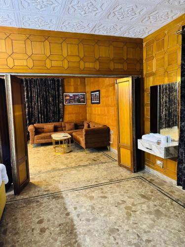 a living room with a couch and a table at Hotel living spot in Lahore