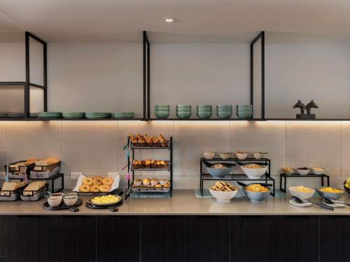 a kitchen with a bunch of food on a counter at Ibis Christchurch in Christchurch