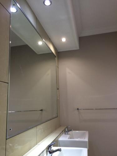 a bathroom with a sink and a large mirror at 314 on Clark Guest House in Pretoria