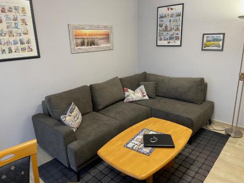 a living room with a couch and a coffee table at Haus Roland, Wohnung 02 in Zinnowitz