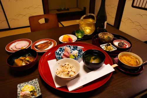 a table with plates of food on a wooden table at 古都とき Kototoki in Kanazawa