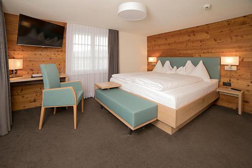 a hotel room with a bed and a table and chairs at Hotel Friedheim Weggis in Weggis