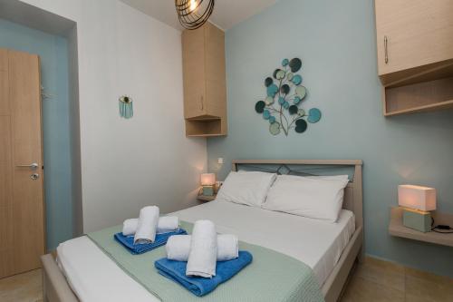 a bedroom with a bed with towels on it at Anastellar in Kissamos