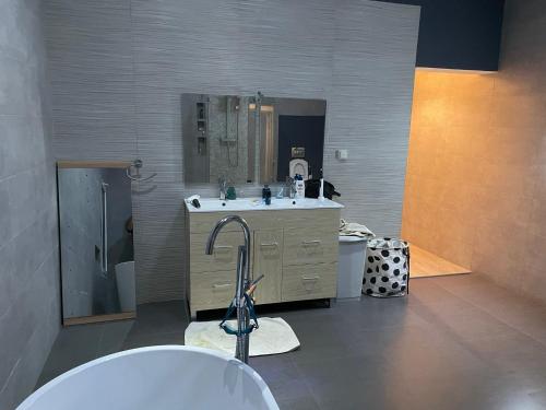 a bathroom with a sink and a mirror at Villa Oasis Antananarivo Private Stay in Antananarivo