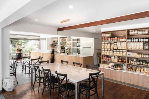 a dining room with a table and some chairs at Family Cozy House near the Bay and the Reserve in Golden Beach