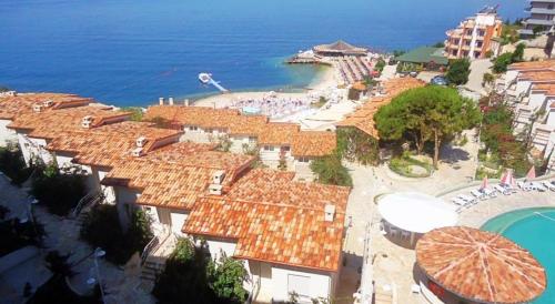 an aerial view of a resort with a pool and the ocean at Sunny Bay Apartments in Sarandë