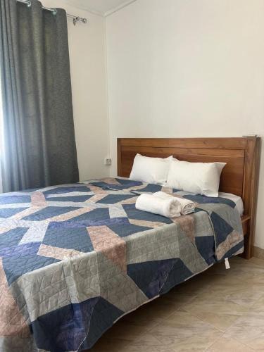 a bedroom with a bed with a quilt on it at TecTec 2 Appartment 2 at Pereybere in Pereybere