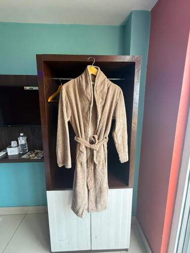 a brown robe is hanging in a closet at Hotel Royal Inn, Nuwakot in Trisūli Bāzār