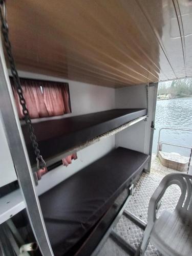a view of the inside of a boat with a chair at Kleines Hausboot - ideal für Ihren Angelurlaub! in Lychen