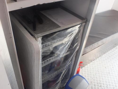 a refrigerator with its door open with food inside at Kleines Hausboot - ideal für Ihren Angelurlaub! in Lychen