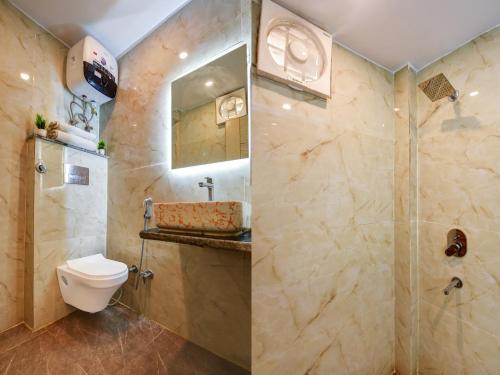 a bathroom with a shower and a toilet and a sink at Hotel Ruhi Dx - Near New Delhi Railway Station & Connaught Place in New Delhi