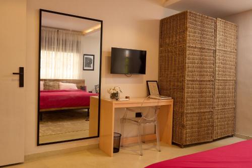 a room with a desk and a mirror and a bedroom at Serenity Room, Design House in Lagos