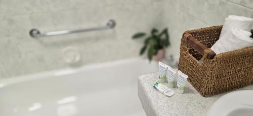 a bathroom with a basket of towels and a bath tub at Family Cozy House near the Bay and the Reserve in Golden Beach