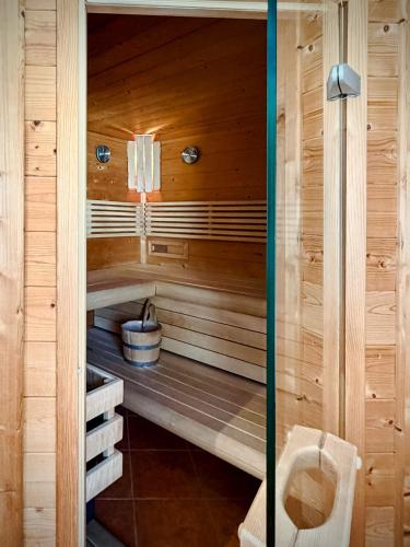 a sauna with a toilet in a wooden cabin at Bioblockhaus Katschberg in Katschberghöhe