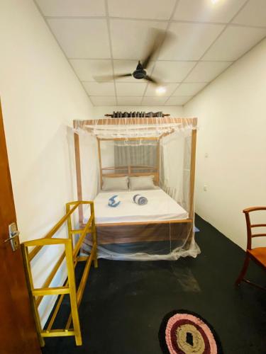 a bunk bed in a room with a ceiling at m&s villa in Weligama