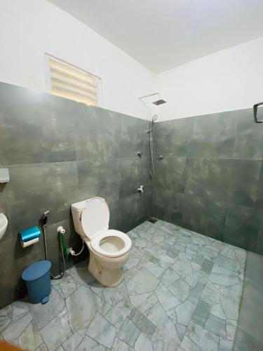 a bathroom with a toilet and a sink at m&s villa in Weligama